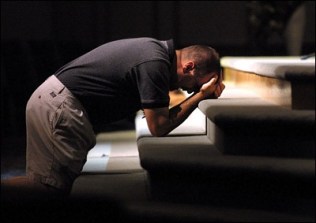 man praying at altar